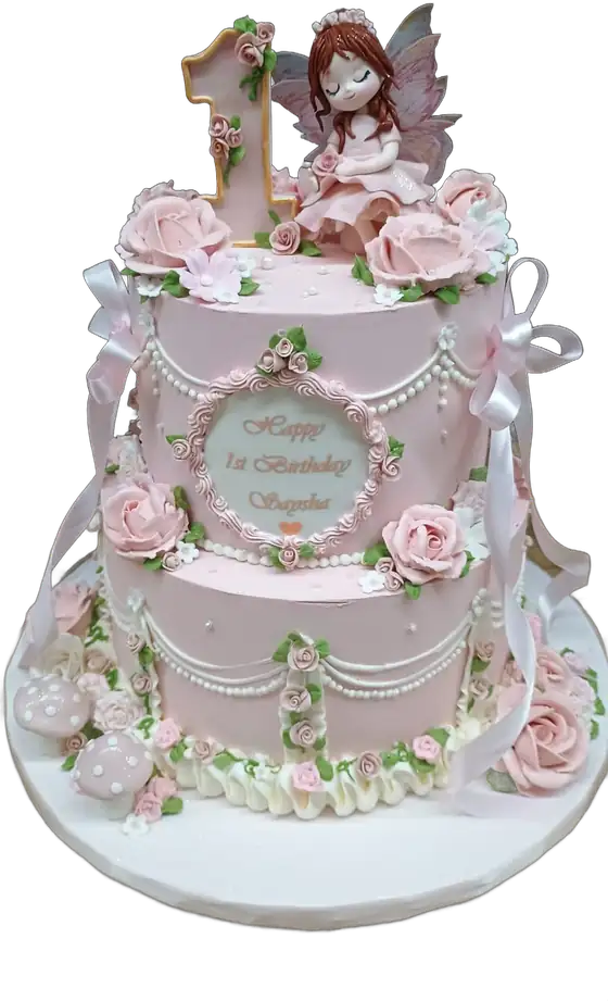 Pink two-tier first birthday cake with fairy topper and buttercream roses
